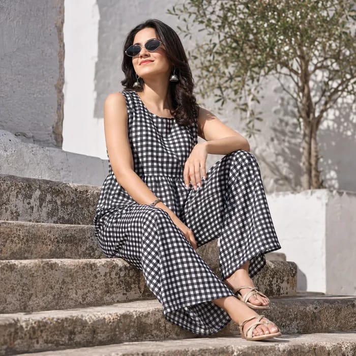Black and white gingham co-ord, worn seated on stone steps